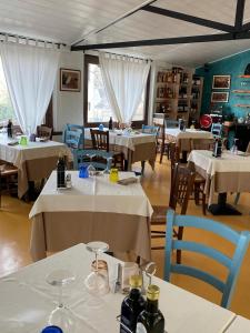 a restaurant with tables and chairs with white tablecloths at Locanda Moscal in Affi