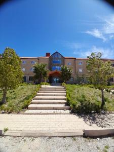 a building with a staircase in front of a building at AUBERGE JOMANA PARK in Azrou