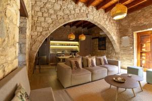 a living room with a couch and a table at Harma Traditional Boutique Suites in Paphos City