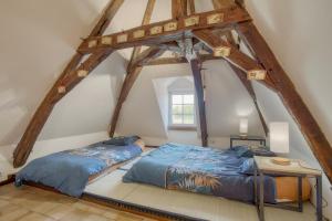 a bedroom with two beds and a table at Jacuzzi et Vue sur Loire - Maison d'hôtes L'Odyssée in La Chapelle-sur-Loire