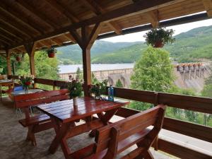a table and benches on a porch with a view at Apartment Dobra vila in Perućac