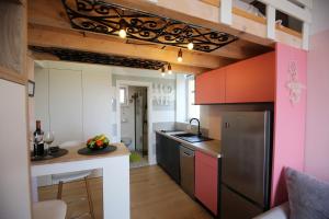 a kitchen with pink and black cabinets and a counter at STUDIO MO in Opatija