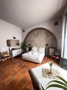 a bedroom with a bed and a table and a tv at Lucilla’s Suite San Pietro station in Rome
