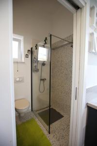 a bathroom with a glass shower with a toilet at STUDIO MO in Opatija