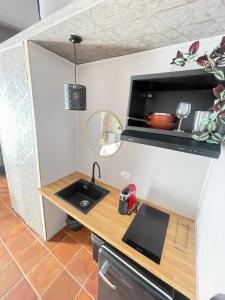 a tiny kitchen with a sink and a counter at Lucilla’s Suite San Pietro station in Rome