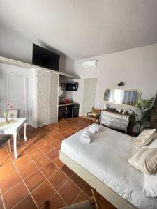 a bedroom with a bed and a table in a room at Lucilla’s Suite San Pietro station in Rome