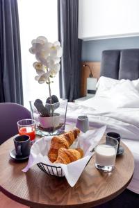 a table with a tray of pastries on top of a bed at Residenze Chamur- Grattacielo in Palermo