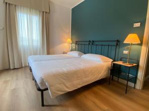 Łóżko lub łóżka w pokoju w obiekcie Locanda Moscal