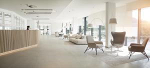 a lobby with a couch and chairs in a building at Hotel Kompas in Dubrovnik