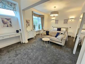 a living room with a couch and a table at ABBEY HOTEL in Stafford