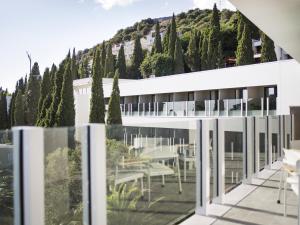 a view from the balcony of a building with trees at Hotel Kompas in Dubrovnik
