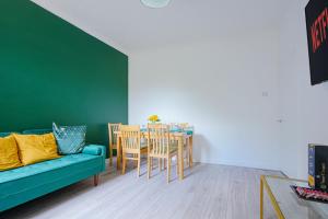 a living room with a couch and a table and chairs at Modern Freshly Refurbed Home Luton in Luton