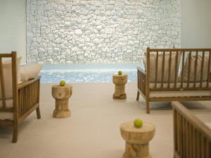 a living room with wooden furniture and a wall at Hotel Kompas in Dubrovnik