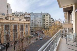 a balcony with a view of a city with buildings at Holodek Apartments- Elysian Harmony in Athens