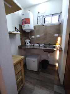 a small bathroom with a sink and aounter at Las Marilubis Calamuchita in Santa Rosa de Calamuchita