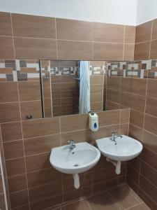 a bathroom with two sinks and a mirror at Penzion U Lipna in Přední Výtoň