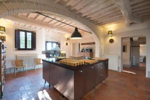 a large kitchen with a large island in a room at Borgo in Montalbano by Secret Hills in Larciano