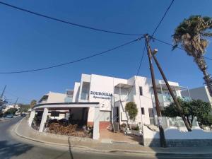 a building on the side of a street at Dinos Pool Apartment in Kardamaina