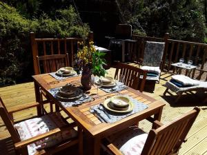 a wooden table with dishes on it on a deck at Deerdale Lodge in Bilsthorpe