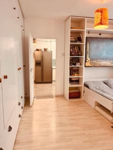 a hallway with a refrigerator in a room at Lorand's Place near the River in Cluj-Napoca