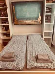 a bed with two pillows in a room at Lorand's Place near the River in Cluj-Napoca