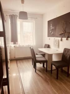 a living room with a table and chairs and a dining room at Lorand's Place near the River in Cluj-Napoca