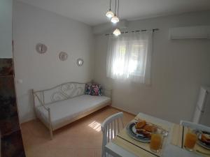 a living room with a couch and a table at Marianna's room in Virós