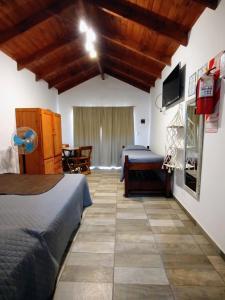 a bedroom with a bed and a dining room at Las Marilubis Calamuchita in Santa Rosa de Calamuchita