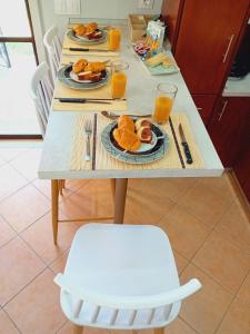 a table with two plates of food and orange juice at Marianna's room in Virós