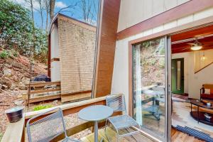 a patio with a table and chairs on a balcony at 30A Creekside in Banner Elk