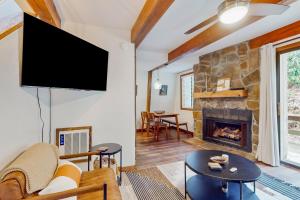 a living room with a fireplace and a flat screen tv at 30A Creekside in Banner Elk