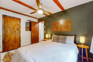 a bedroom with a white bed and a green wall at 30A Creekside in Banner Elk