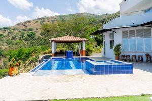 a house with a swimming pool with a gazebo at Finca Rosa Linda Stunning Views Jacuzzi Pool in Sopetrán