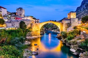 a bridge over a river in front of a city at 3-Bedroom NewHome in Mostar