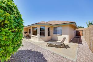 a house with a table and a chair in front of it at Mesa Home in 55 and Community with Patio and Gas Grill! in Mesa