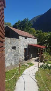 a stone building with a red roof at Nature Retreat - Laurel Forest in Seixal