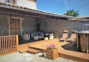 a wooden deck with two chairs and a table at Escale à Pelagrua in Pellegrue