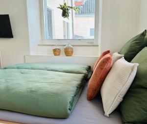 a room with two pillows on a bed with a window at Ferienwohnung Lieblingsort in Kempten