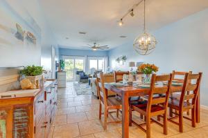a dining room and living room with a table and chairs at Water View Dauphin Island Condo with Boat Slips in Dauphin Island