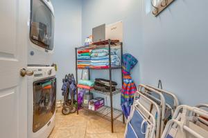 a towel rack in a room with a washing machine at Water View Dauphin Island Condo with Boat Slips in Dauphin Island