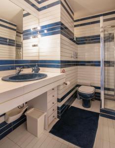 ein Badezimmer mit Waschbecken und Toilette in der Unterkunft Vouliagmeni Sea and Sun Apartment in Athen + 10 Fotos