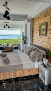 a bedroom with a large bed with a view of the ocean at Villa castros delmare in Vragkaniótika