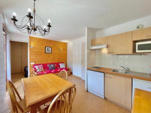 a kitchen and dining room with a wooden table at Appartement Flumet, 2 pièces, 4 personnes - FR-1-505-206 in Flumet