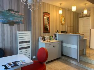 a hair salon with a red chair and a desk at Omr park Suites in Istanbul