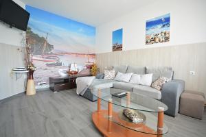 a living room with a couch and a glass table at Casa de playa en un pequeño paraíso in Isla de Arosa