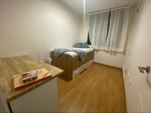 a small bedroom with a small bed and a window at Balcón del atardecer in Barbate