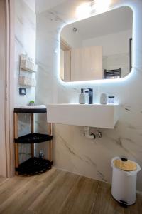 a bathroom with a sink and a mirror at Aella Apartment in Skala Kefalonias +18 photos