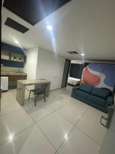 a living room with a couch and a table at Imperial Tambau By Loui in João Pessoa