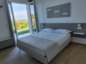 Postel nebo postele na pokoji v ubytování Le Nereidi Green Resort Elisa