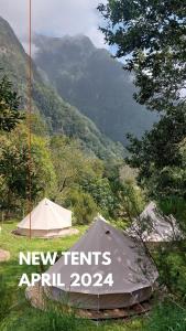 a tent with a sign on it in front of a mountain at Nature Retreat - Laurel Forest in Seixal